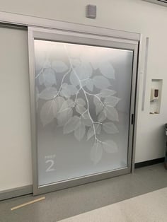 A glass door with a frosted window graphic